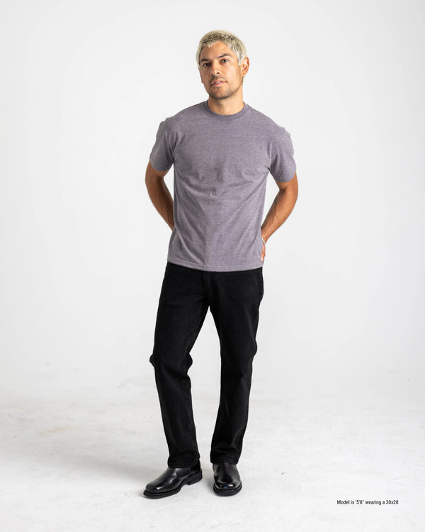 shorter guy posed in jeans and a t-shirt