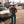 Load image into Gallery viewer, Man standing next to a vintage Mercedes-Benz car on a city street.

