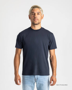 Shorter Man wearing a plain black t-shirt and blue jeans against a gray background
