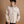 Load image into Gallery viewer, A short male model wearing a tan flannel button-up shirt over a white T-shirt against a warm brown studio backdrop.
