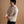 Load image into Gallery viewer, A short male model wearing a tan flannel button-up shirt and dark pants, shown from the side against a warm brown studio backdrop.
