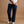 Load image into Gallery viewer, A model wearing dark blue straight-leg denim jeans, a white t-shirt, and white sneakers, standing against a solid tan studio backdrop.
