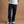 Load image into Gallery viewer, A person wearing dark blue straight-leg jeans, a white t-shirt, and white sneakers with black stripes, standing against a solid tan studio background.
