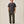 Load image into Gallery viewer, A man stands against a plain warm beige studio background wearing a dark charcoal gray short-sleeve crewneck t-shirt, olive green pants, and white sneakers. Small text in the bottom right corner reads 'Model wearing a 32x28'.
