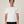 Load image into Gallery viewer, A man wearing a plain white short-sleeve crewneck t-shirt and black pants, standing against a solid light beige background.
