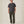 Load image into Gallery viewer, A man modeling a dark charcoal gray crewneck t-shirt and olive green pants against a plain beige studio background.
