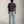 Load image into Gallery viewer, Short male Person wearing a dark gray t-shirt and light blue jeans against a plain background

