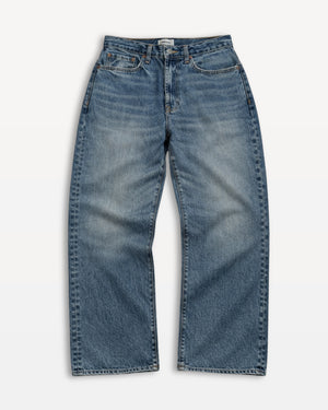 Short Man wearing a plain gray t-shirt and light blue jeans on a white background