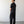 Load image into Gallery viewer, Man wearing a black outfit standing against a white wall.
