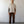 Load image into Gallery viewer, Man wearing a beige shirt and brown pants standing against a white wall.
