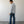 Load image into Gallery viewer, Man wearing a light blue shirt and dark jeans standing against a plain white wall.
