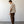 Load image into Gallery viewer, Man wearing a beige shirt and brown pants standing against a white wall.
