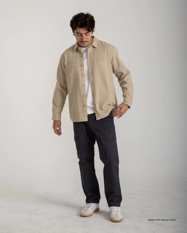 Person wearing a dark gray t-shirt and black pants on a white background