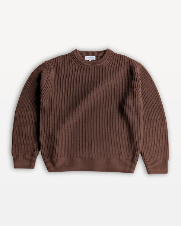 Brown sweater on a light beige background