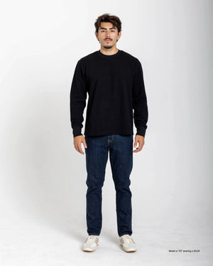 Short Man wearing a white sweater and blue jeans on a white background