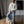 Load image into Gallery viewer, Short Man in a white sweater and blue jeans standing on a wooden box in a studio setting.
