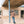 Load image into Gallery viewer, Short Man standing under a blue overhang in front of a building
