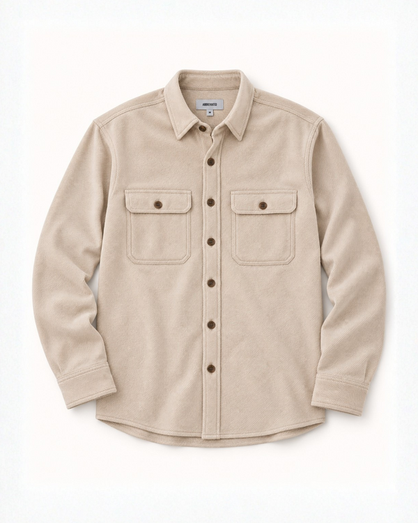 A light beige long-sleeve button-up shirt with two buttoned chest pockets, laid flat against a clean white background.