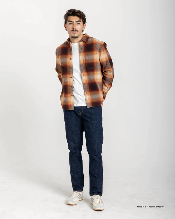 5'8" Man wearing a plaid shirt, white t-shirt, blue jeans, and white sneakers on a white background