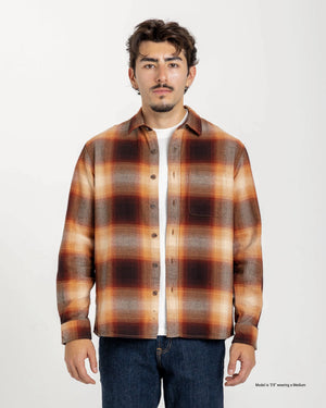 Short Man wearing a brown plaid shirt on a white background