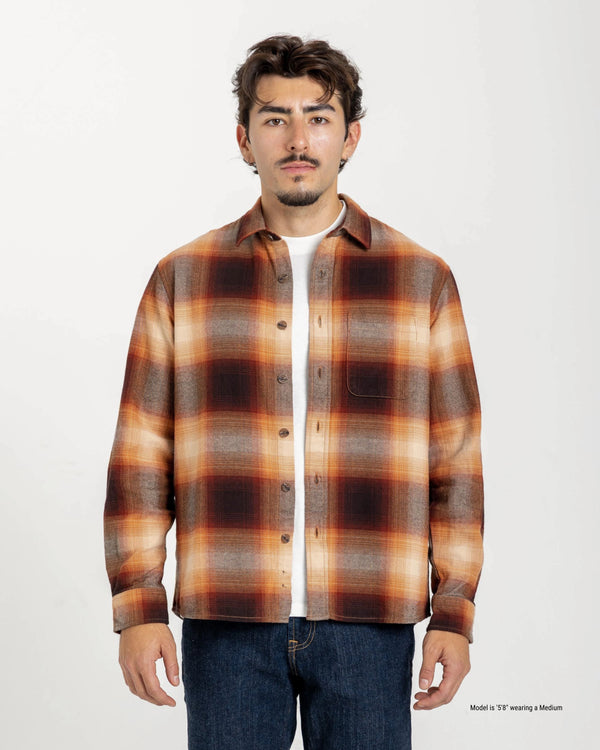 Short Man wearing a brown plaid shirt on a white background