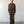 Load image into Gallery viewer, Man wearing a brown shirt and pants standing against a white wall.
