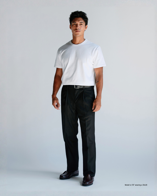 Black loose pleated trousers styled with a white t-shirt and black belt on a 5'8" man, full-length front view