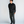 Load image into Gallery viewer, 5'8" man wearing charcoal loose pleated trousers in a 30x28 with a black textured sweater and burgundy loafers
