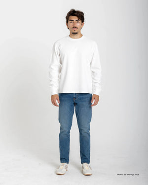 Short Man wearing a white sweater and blue jeans on a white background