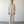 Load image into Gallery viewer, Man wearing a beige shirt and pants standing against a white wall.
