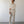 Load image into Gallery viewer, Man wearing a beige shirt and pants standing against a white wall.
