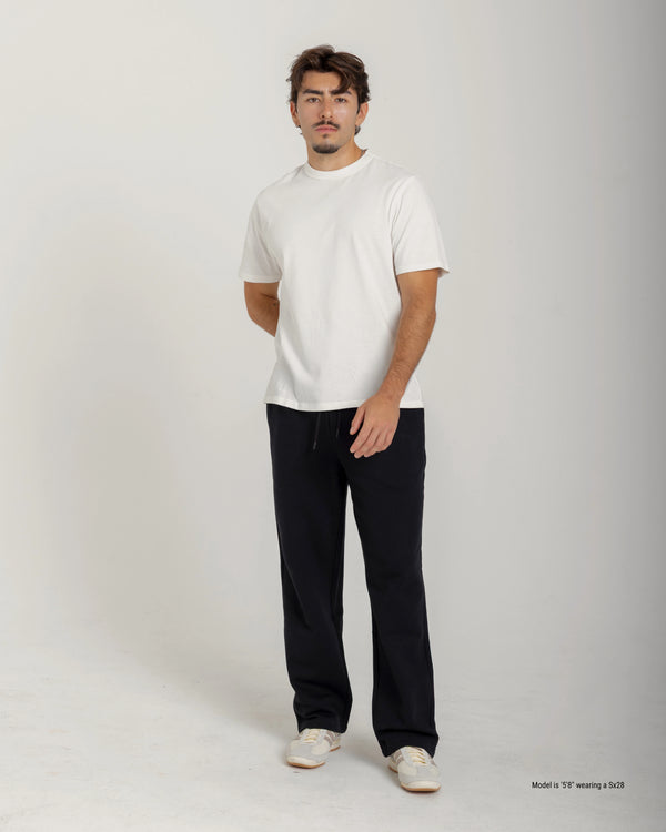 Short Man wearing a white t-shirt and black pants on a plain background