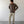 Load image into Gallery viewer, Shorter Man wearing a brown shirt and beige pants standing against a white wall.
