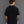 Load image into Gallery viewer, Man wearing a black short-sleeve shirt against a gray background
