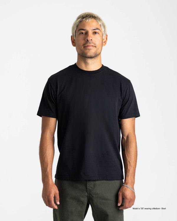 Man wearing a black t-shirt against a white background