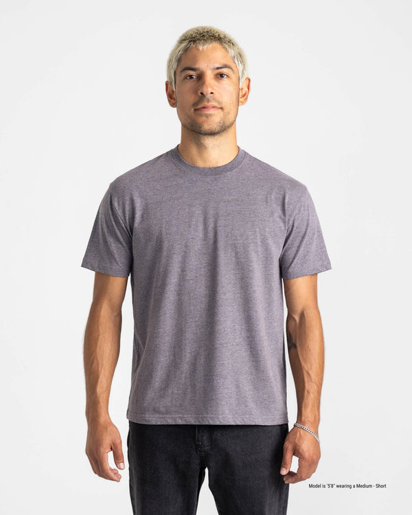 Man wearing a plain gray t-shirt against a white background