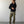 Load image into Gallery viewer, Man wearing a black jacket and green pants standing against a plain white wall.
