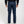 Load image into Gallery viewer, Person wearing blue jeans from behind on a white background
