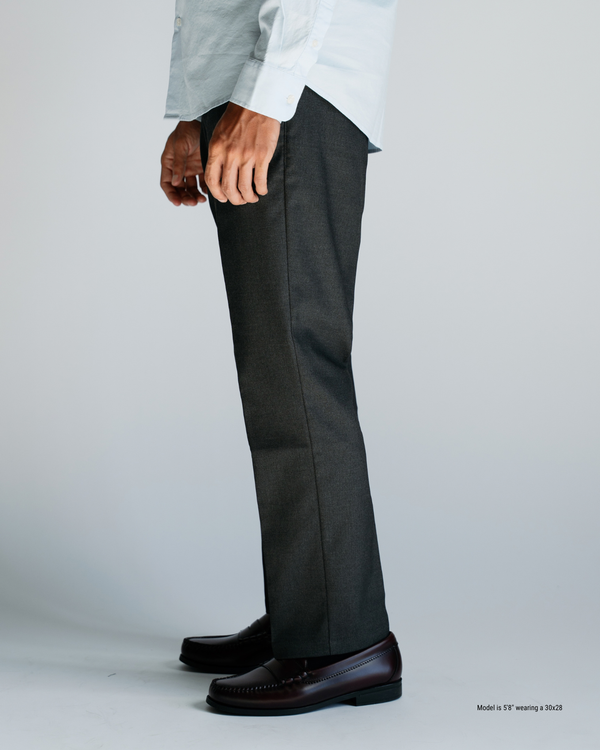 Side profile of charcoal straight menswear trousers proportioned for shorter men, worn with loafers
