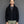 Load image into Gallery viewer, Short Man wearing a black hoodie against a gray background
